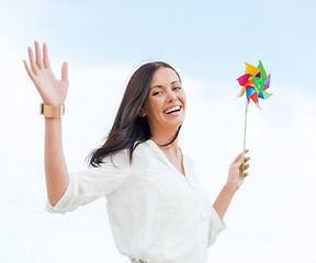 Image showing girl with windmill toy on the beach