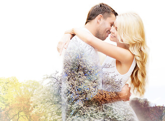 Image showing happy couple hugging over cherry blossom