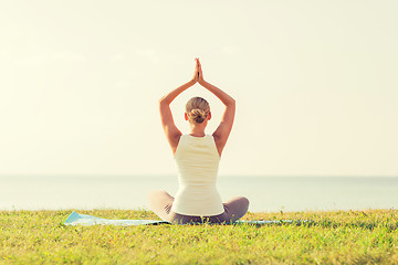 Image showing woman making yoga exercises outdoors