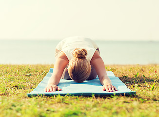 Image showing close up of woman making yoga exercises outdoors