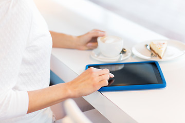 Image showing close up of woman with tablet pc drinking coffee