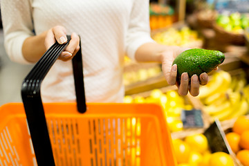 Image showing close up of woman with food basket in market