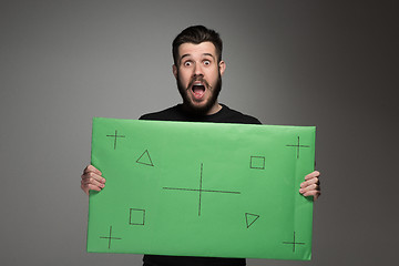 Image showing The surprised man as businessman with green panel