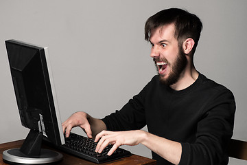 Image showing Funny and crazy man using a computer