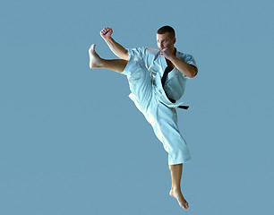 Image showing Man in white kimono training karate