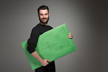 Image showing The smiling man as businessman with green panel