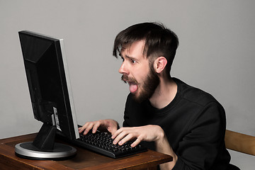 Image showing Funny and crazy man using a computer