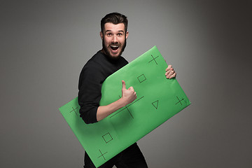 Image showing The smiling man as businessman with green panel