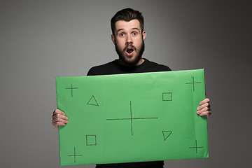 Image showing The surprised man as businessman with green panel