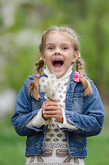Image showing Six year old girl with dandelions fun smiling