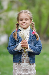 Image showing Six year old girl with dandelions