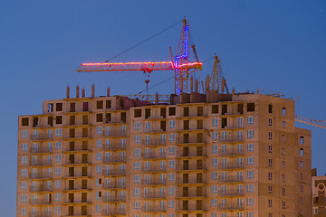 Image showing View after sunset on the unfinished house with a crane