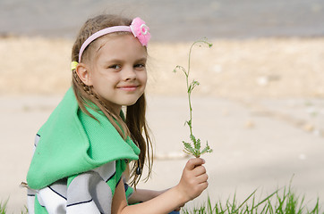 Image showing Girl with blade of grass in hands