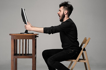 Image showing Funny and crazy man using a computer