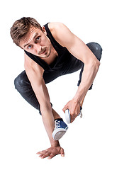 Image showing Break dancer doing one handed handstand against a white background