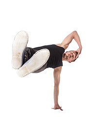 Image showing Break dancer doing one handed handstand against a white background