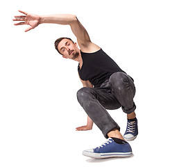 Image showing Break dancer doing one handed handstand against a white background