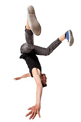 Image showing Break dancer doing one handed handstand against a white background