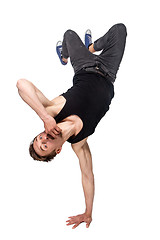 Image showing Break dancer doing one handed handstand against a white background