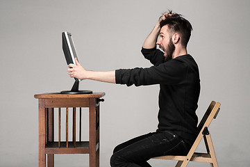 Image showing Funny and crazy man using a computer