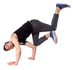 Image showing Break dancer doing handstand against  white background