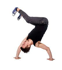 Image showing Break dancer doing handstand against  white background