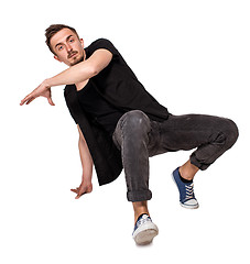 Image showing Break dancer doing one handed handstand against a white background