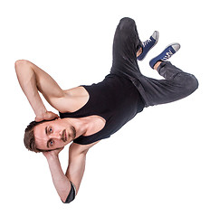 Image showing Break dancer doing one handed handstand against a white background