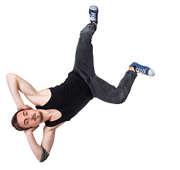 Image showing Break dancer doing one handed handstand against a white background