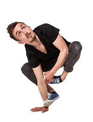 Image showing Break dancer doing one handed handstand against a white background