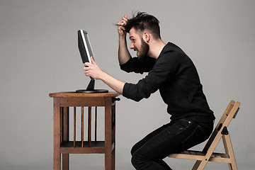 Image showing Funny and crazy man using a computer