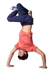 Image showing Break dancer doing handstand against  white background