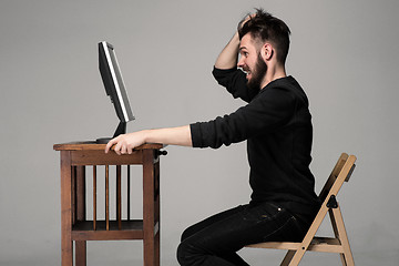 Image showing Funny and crazy man using a computer