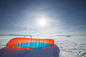 Image showing Kiteboarder with blue kite on the snow