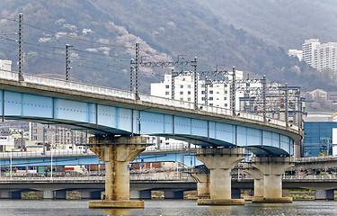 Image showing train bridge across river and city background at busan