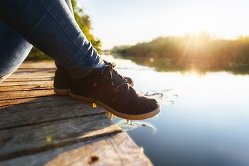 Image showing Woman relaxing on jetty