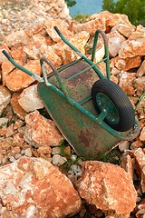 Image showing Wheelbarrow on red rocks