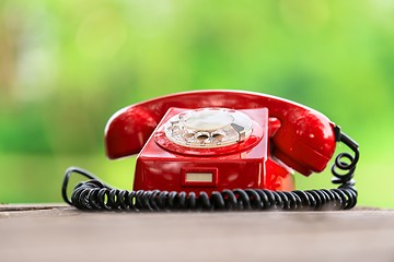 Image showing Red phone on wooden deck