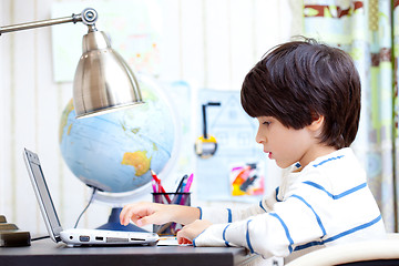 Image showing schoolchild working on a computer