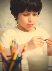 Image showing boy chooses a pencil