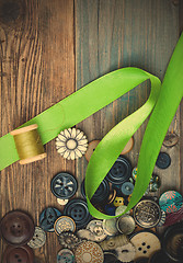 Image showing set of vintage buttons with green tape and spool of thread