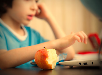 Image showing bitten apple and a boy with computer