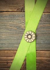 Image showing Vintage metal button flower and two green tape