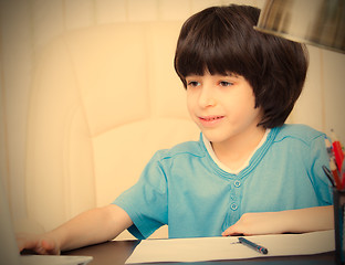 Image showing boy doing homework with computer