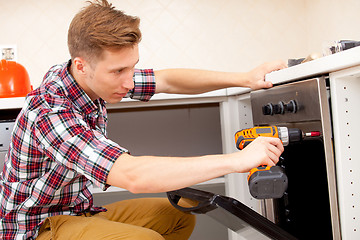 Image showing expert panel fixing the kitchen oven