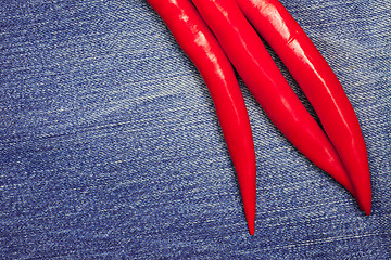 Image showing red pepper on jeans background