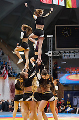 Image showing Acrobatic jump show cheerleaders