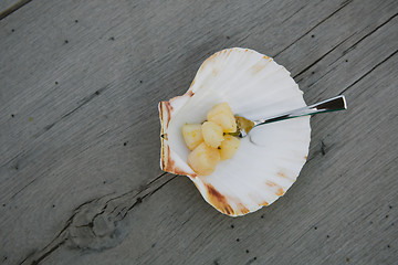 Image showing Delicious sea scallop on wooden background