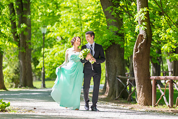 Image showing Wedding couple walking in park.