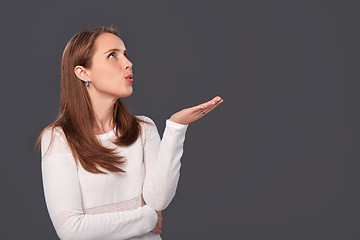 Image showing Profile portrait of a woman blowing on palms